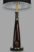 Liquor bottle lamp made from a reclaimed Don Julio 1942 Tequila bottle, front view, on a gray background