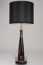 Liquor bottle lamp made from a reclaimed Don Julio 1942 Tequila bottle, full view, light off, on a gray background