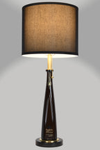 Liquor bottle lamp made from a reclaimed Don Julio 1942 Tequila bottle, full view, light on, on a gray background