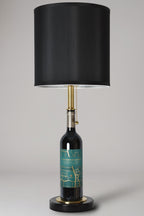 Wine bottle lamp made from a reclaimed 2022 Crossroads Cabernet Franc bottle, full view, light off, on a gray background