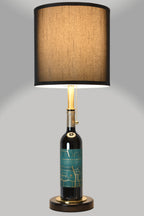 Wine bottle lamp made from a reclaimed 2022 Crossroads Cabernet Franc bottle, full view, light on, on a gray background