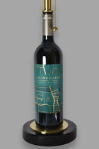 Wine bottle lamp made from a reclaimed 2022 Crossroads Cabernet Franc bottle, close-up view, on a gray background