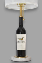 Wine bottle lamp made from a reclaimed 2022 Decoy Cabernet Sauvignon bottle, front view, on a gray background