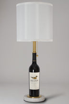 Wine bottle lamp made from a reclaimed 2022 Decoy Cabernet Sauvignon bottle, full view, light off, on a gray background