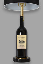 Wine bottle lamp made from a reclaimed 2016 Duckhorn Magnum Cabernet Sauvignon bottle, front view, on a gray background