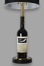 Wine bottle lamp made from a reclaimed 2017 Frog's Leap Cabernet Sauvignon bottle, front view, on a gray background