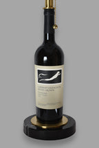 Wine bottle lamp made from a reclaimed 2017 Frog's Leap Cabernet Sauvignon bottle, close-up view, on a gray background