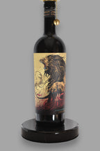 Wine bottle lamp made from a reclaimed Juggernaut Cabernet Sauvignon bottle, close-up view, on a gray background