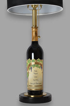 Wine bottle lamp made from a reclaimed 2022 Nickel & Nickel Cabernet Sauvignon bottle, front view, on a gray background