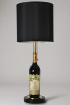 Wine bottle lamp made from a reclaimed 2022 Nickel & Nickel Cabernet Sauvignon bottle, full view, light off, on a gray background