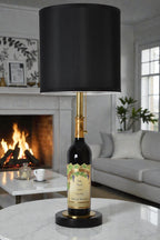 Wine bottle lamp made from a reclaimed 2022 Nickel & Nickel Cabernet Sauvignon bottle, full view, light off, in a cozy living room