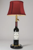 Wine bottle lamp made from a reclaimed 2014 O'Leary Cabernet Sauvignon bottle, full view, light off, on a gray background