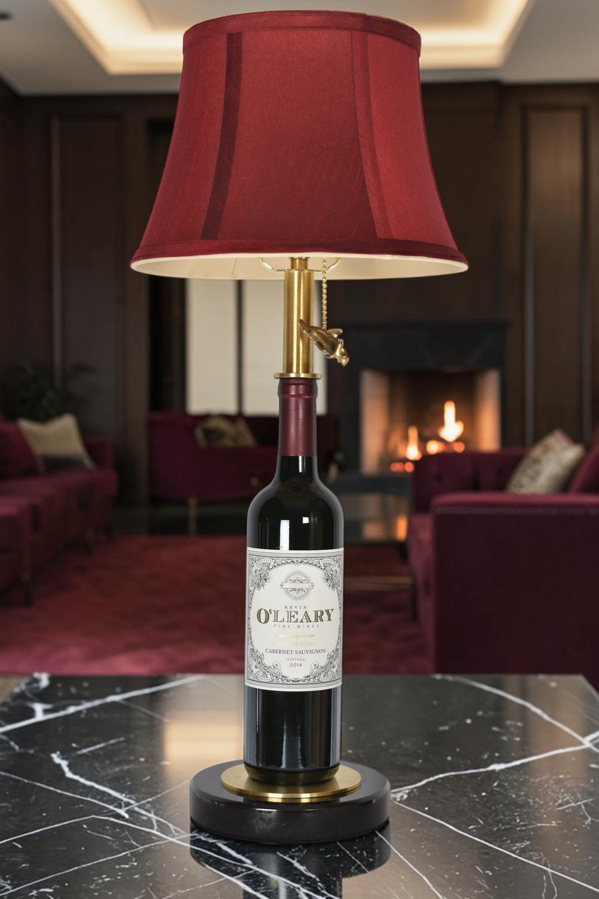 Wine bottle lamp made from a reclaimed 2014 O'Leary Cabernet Sauvignon bottle, full view, light off, in a cozy living room