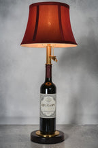 Wine bottle lamp made from a reclaimed 2014 O'Leary Cabernet Sauvignon bottle, full view, light on, on a gray background