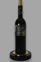 Wine bottle lamp made from a reclaimed 2021 Paul Hobbs Cabernet Sauvignon bottle, close-up view, on a gray background