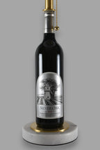 Wine bottle lamp made from a reclaimed 2020 Silver Oak Cabernet Sauvignon bottle, close-up view, on a gray background
