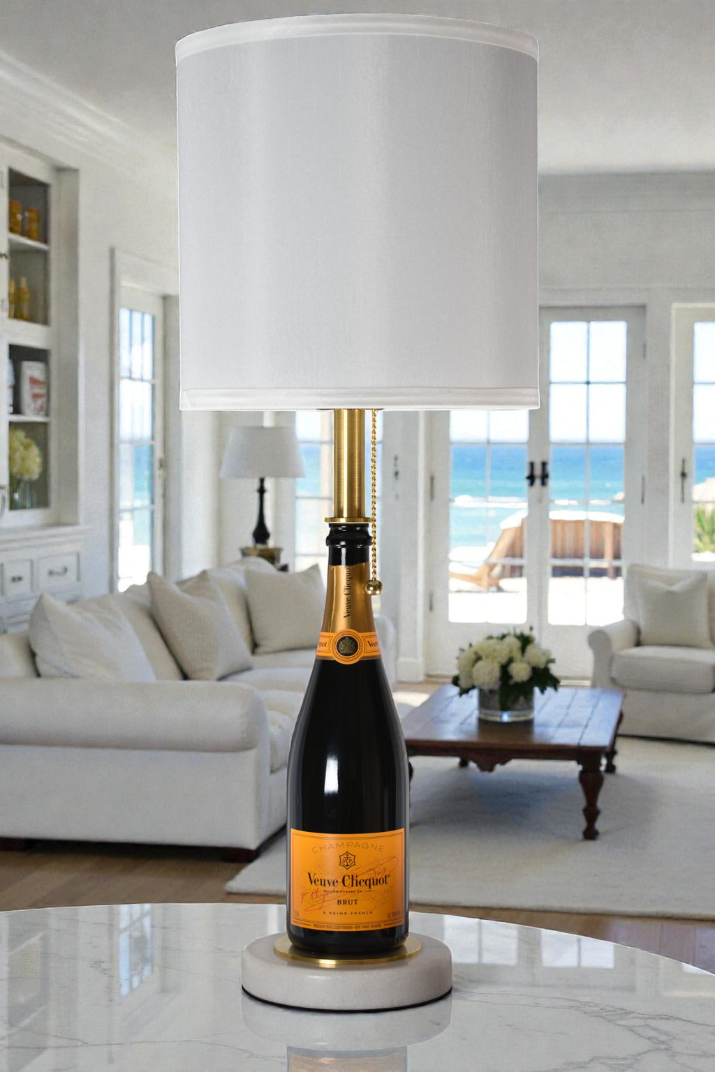 Wine bottle lamp made from a reclaimed Veuve Clicquot Brut Champagne bottle, full view, light off, in a cozy living room